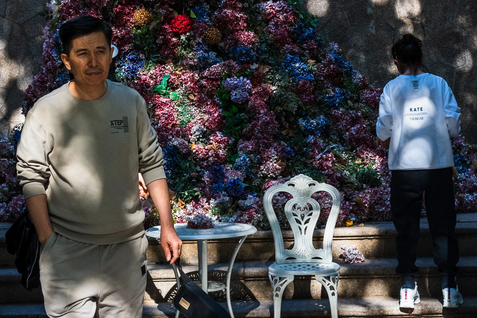 花墙前的人与投在墙上的人影
